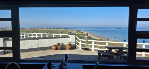 a view of the beach from a window at Royal Court Hotel in Portrush