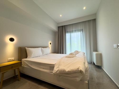 a bedroom with a large bed and a window at VILLA 8 By ProLiving Hospitality in Thessaloniki