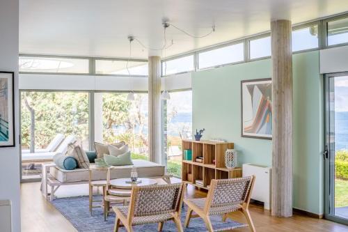 a living room with a couch and chairs and a table at Lefkon Villa with pool by the Sea - NPeloponnese in Kato Rodini