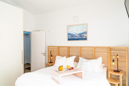 a bedroom with a white bed and a table at Lefkon Villa with pool by the Sea - NPeloponnese in Kato Rodini