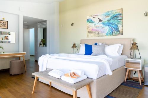 a bedroom with a large white bed and a table at Lefkon Villa with pool by the Sea - NPeloponnese in Kato Rodini