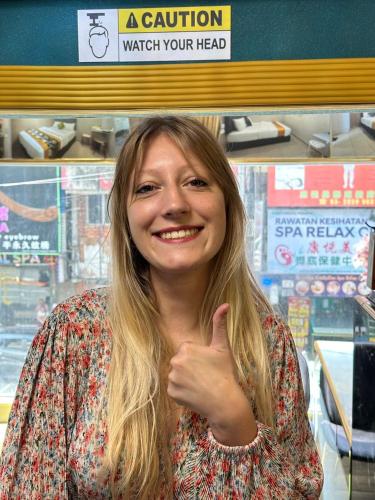 a woman giving a thumbs up in a store at SS Grey Hotel Bukit Bintang in Kuala Lumpur