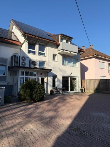 a large white house with a brick driveway at Miyabi 1 in Maribor
