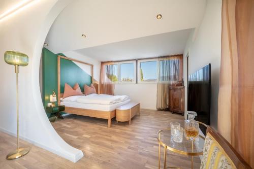 a bedroom with a bed and a glass table at Villa Maria Boutique Apartment St Pauls in Appiano sulla Strada del Vino