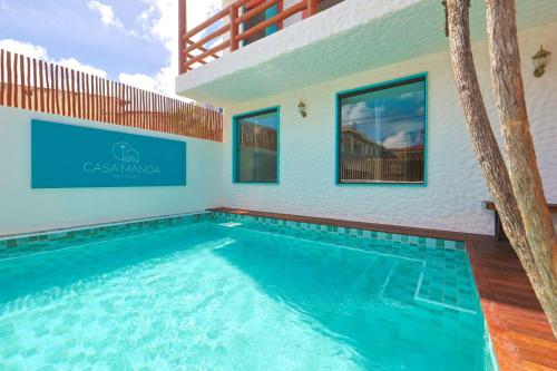 a swimming pool in the middle of a house at Casa Manoa Pousada in Maragogi