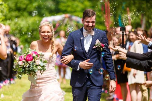 a bride and groom walking down the aisle at Pension Tereza & Šumavské Roubenky in Sušice