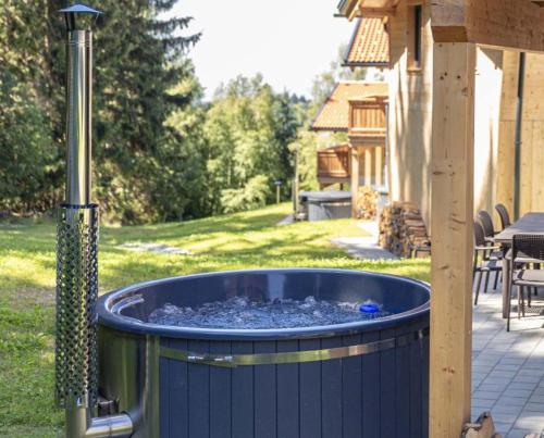 a large blue barrel sitting in a yard at Luxalps- Chalets Inzell- Sauna- Skifahren- Wandern- Natur- Chiemgau Card in Inzell