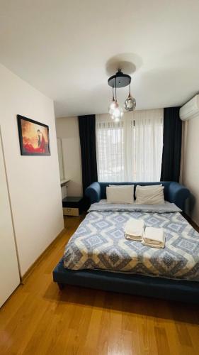 a bedroom with a bed with two towels on it at CTS Elysium Residence Taksim in Istanbul