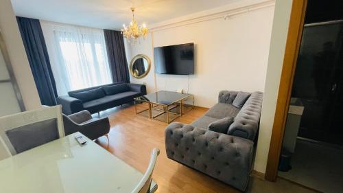 a living room with a couch and a table at CTS Elysium Residence Taksim in Istanbul