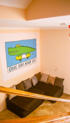 a living room with a couch and a sign at Hostel Albania Villa in Tirana