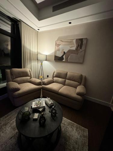 a living room with a couch and a table at Kindah Apartment in Jeddah