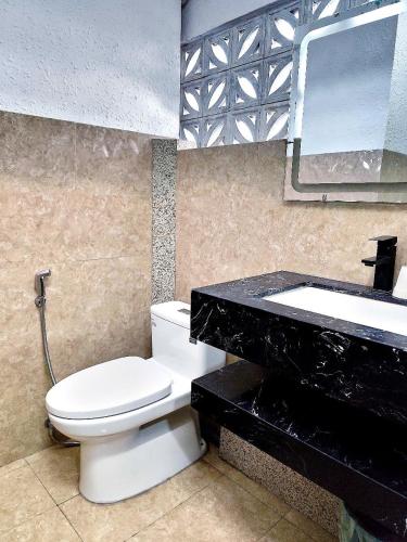 a bathroom with a white toilet and a sink at Sea Night - Sea Home Hotel in Phan Thiet