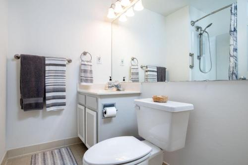 a white bathroom with a toilet and a sink at Summer Winds 231-B condo in Salter Path