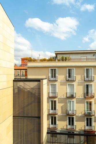 an apartment building with balconies and a black gate at Ocean Drive Madrid in Madrid