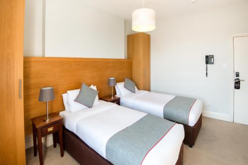 a hotel room with two beds and a lamp at Dancenter Bristol near Clifton Down Station in Bristol