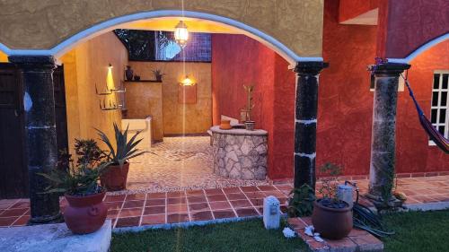 a room with an archway with plants and a table at Casa Colonial Cozumel, Villa Mango in Cozumel