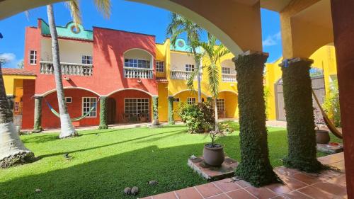 a courtyard of a building with palm trees at Casa Colonial Cozumel, Villa Mango in Cozumel