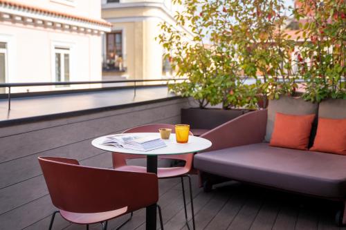 a table and chairs sitting on a balcony at Ocean Drive Madrid in Madrid