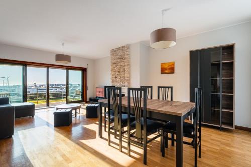 a dining room and living room with a table and chairs at GuestReady - Chilled getaway near Porto in Vila Nova de Gaia