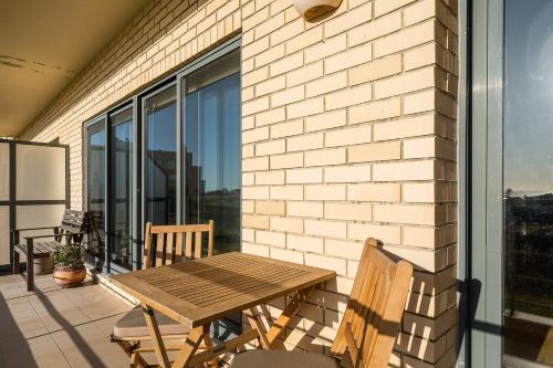 a patio with a wooden table and chairs on a balcony at GuestReady - Chilled getaway near Porto in Vila Nova de Gaia