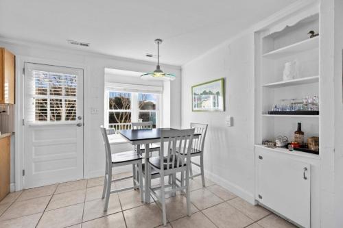 a kitchen with a dining room table and chairs at Salt Life home in Atlantic Beach