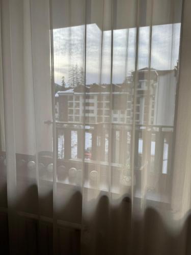 a window with a view of a building at Borovets Gardens MVS Apart D42 in Borovets