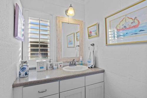 a bathroom with a sink and a mirror at Salt Life home in Atlantic Beach
