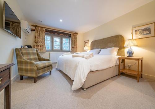 a bedroom with a large bed and a chair at The Fleece Inn in Shireshead