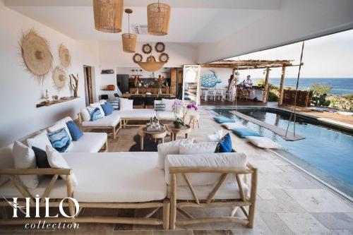 a villa with a swimming pool and a living room at Turtle Beach Villa les 3 Bassins by HILO Collection - 14 people - Pool, gym and Ocean private access in La Saline Les hauts 