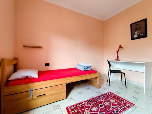 a bedroom with a wooden bed and a desk at Hostel Albania Villa in Tirana