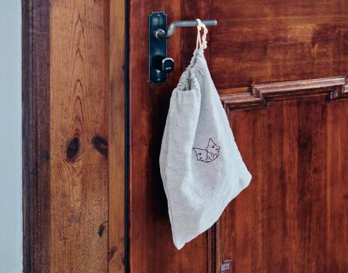 a towel hanging on a door with a fish on it at Engelwirt Hotel & Apartments in Berching