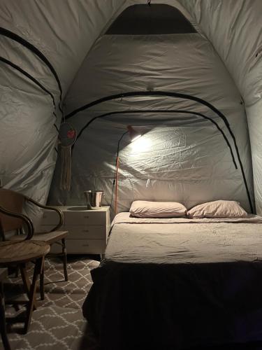 a bedroom with a bed in a tent at Roof top glamping and Toys suites in Eilat