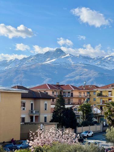 a group of buildings with snow capped mountains in the background at Casa Aurora in Biella