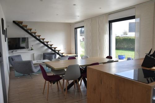 un salon avec une table et des chaises en bois dans l'établissement Les Hauts de Trégana, à Loc-Maria-Plouzané