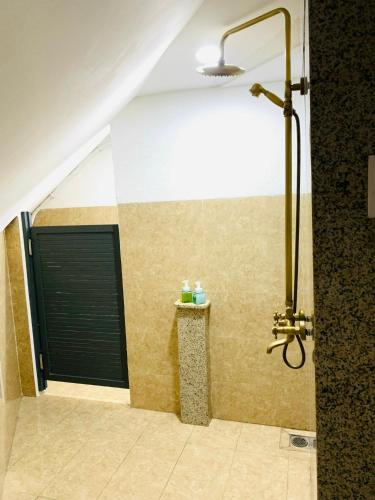 a shower with a black door in a bathroom at Sea Night - Sea Home Hotel in Phan Thiet