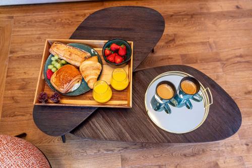 a tray of breakfast foods on a table at Villa SoPi Appart'Hotel by Patrick Hayat in Paris