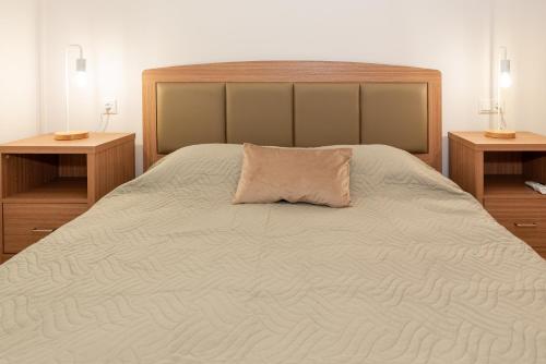 a bedroom with a large bed with a pillow on it at Nina's Apartments in Kómi