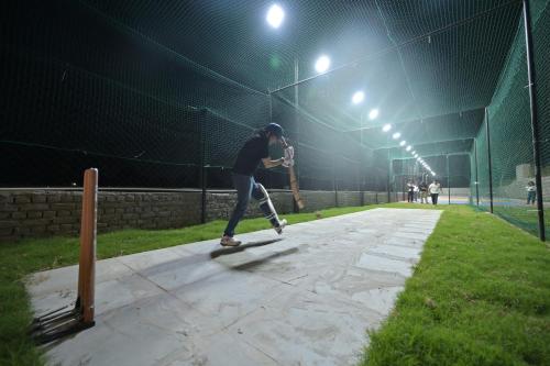 a man riding a skateboard on a court at night at Clarks Safari Haridwar in Haridwār