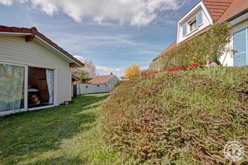 a house with a large bush in the yard at Au plein soleil in Chazelles-sur-Lyon