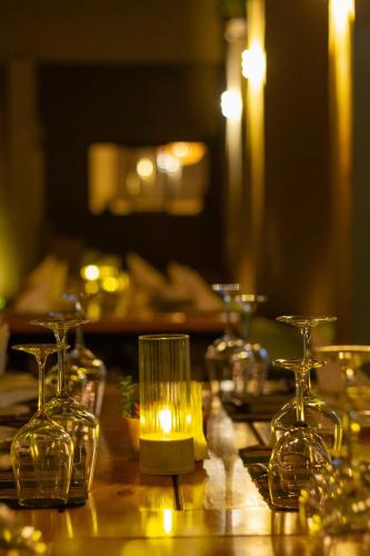 a table with several glasses and a candle on it at Trisan Resident Hotel in Nairobi