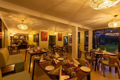 a restaurant with tables and chairs in a room at Trisan Resident Hotel in Nairobi