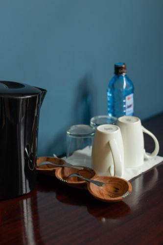 a table with two cups and a plate with two spoons at Trisan Resident Hotel in Nairobi