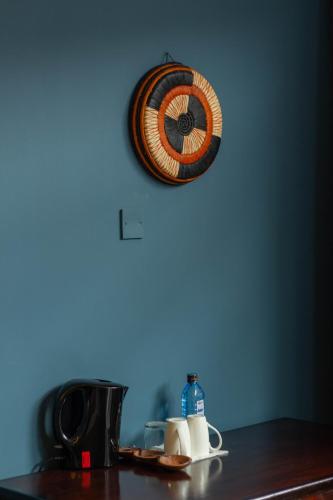 a clock on a wall above a kitchen counter at Trisan Resident Hotel in Nairobi