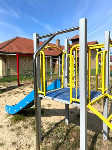 a playground with a yellow and blue slide at Forest Mood in Wieck