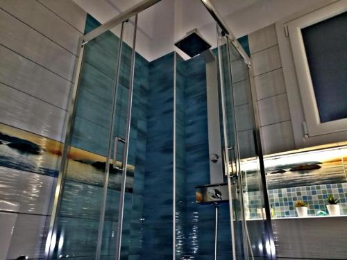 a shower with a glass door in a bathroom at Fantastic View Suite Kythnos in Kithnos