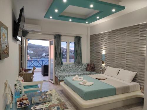 a bedroom with a large bed and a balcony at Fantastic View Suite Kythnos in Kithnos