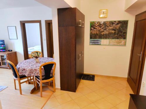 a dining room with a table and chairs at Apartments Tatra Olla - Tatranská Lomnica in Tatranská Lomnica