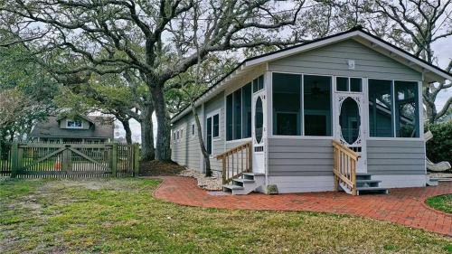 a small house with a porch and a fence at Mr, Bennie's Cafe home in Harkers Island
