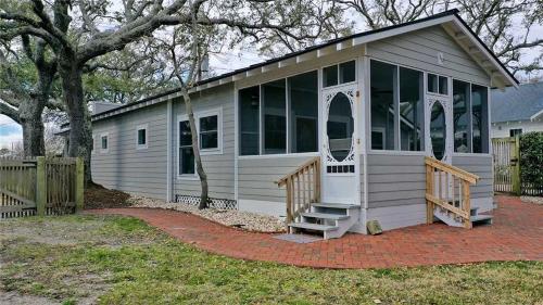 a tiny house with a porch and large windows at Mr, Bennie's Cafe home in Harkers Island