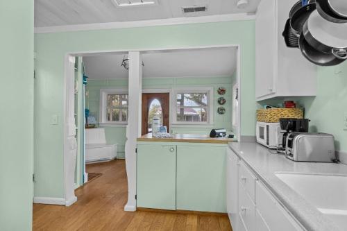 a kitchen with white cabinets and a counter top at Mr, Bennie's Cafe home in Harkers Island
